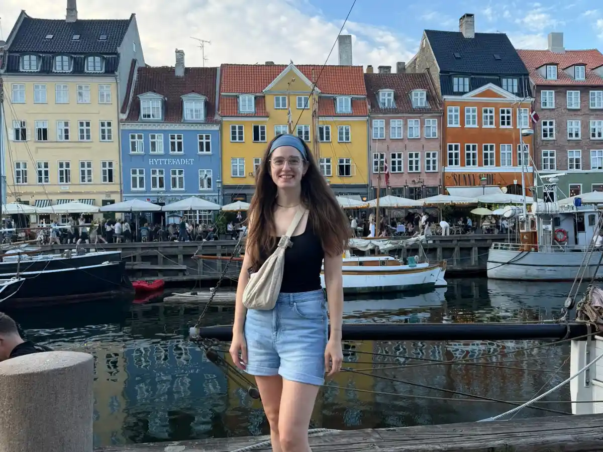 Katie with the colourful buildings in Nyhavn, Copenhagen Denmark